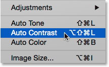 Selecting the Auto Contrast command from under the Image menu in Photoshop. 