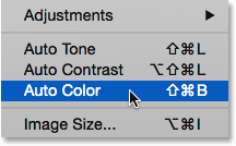 Selecting the Auto Color command from under the Image menu in Photoshop. Image © 2015 Photoshop Essentials.com